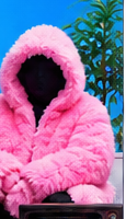 A faceless person wearing an oversized pink fluffy hooded jacket.